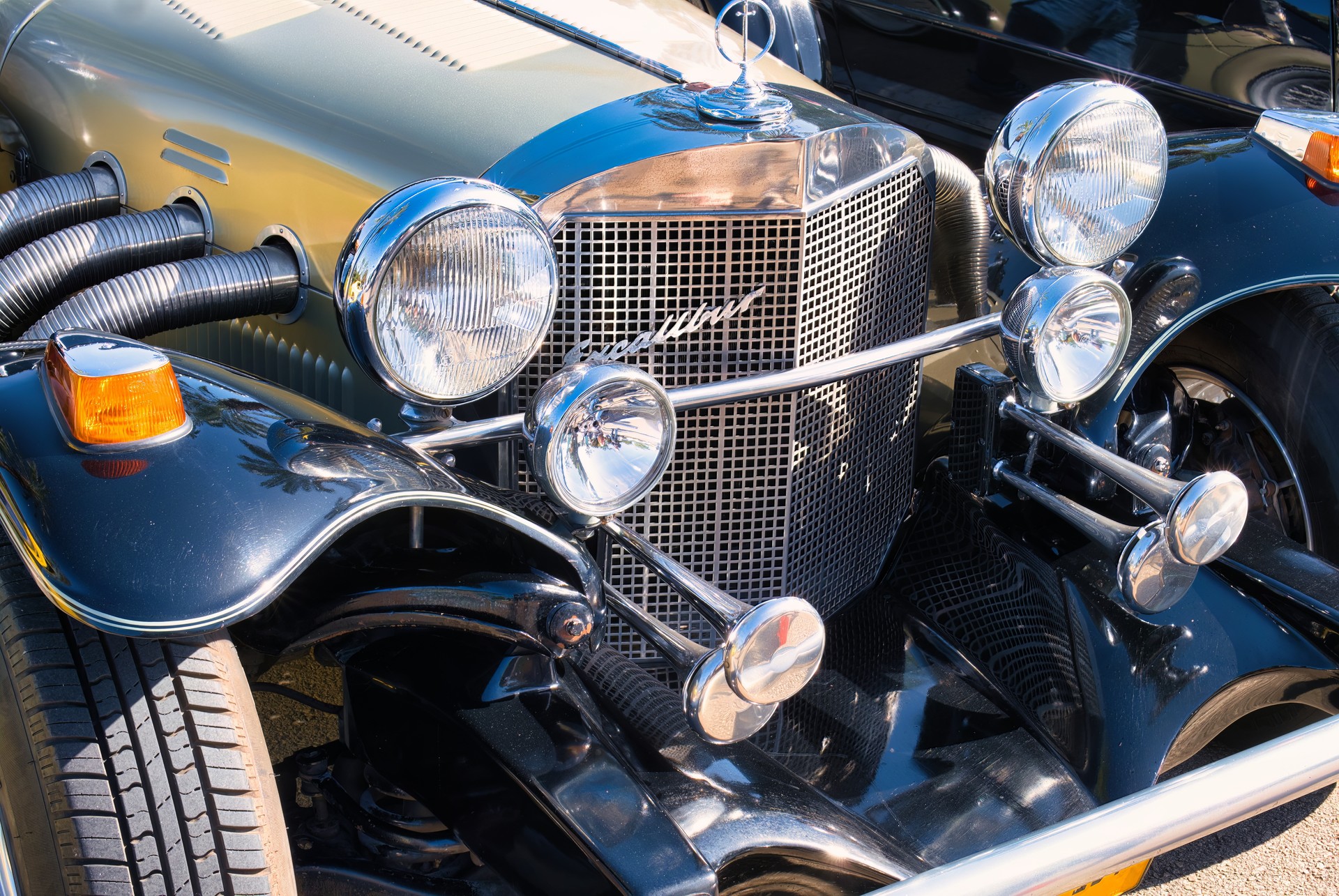 Exhibition of vintage collectible cars, Excalibur SS Roadster Studebaker retro car, front view of an american classic car.